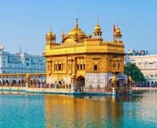 Golden Temple (Harmandir Sahib) in Amritsar, surrounded by the holy pool with visitors walking along the marble causeway at daylight.